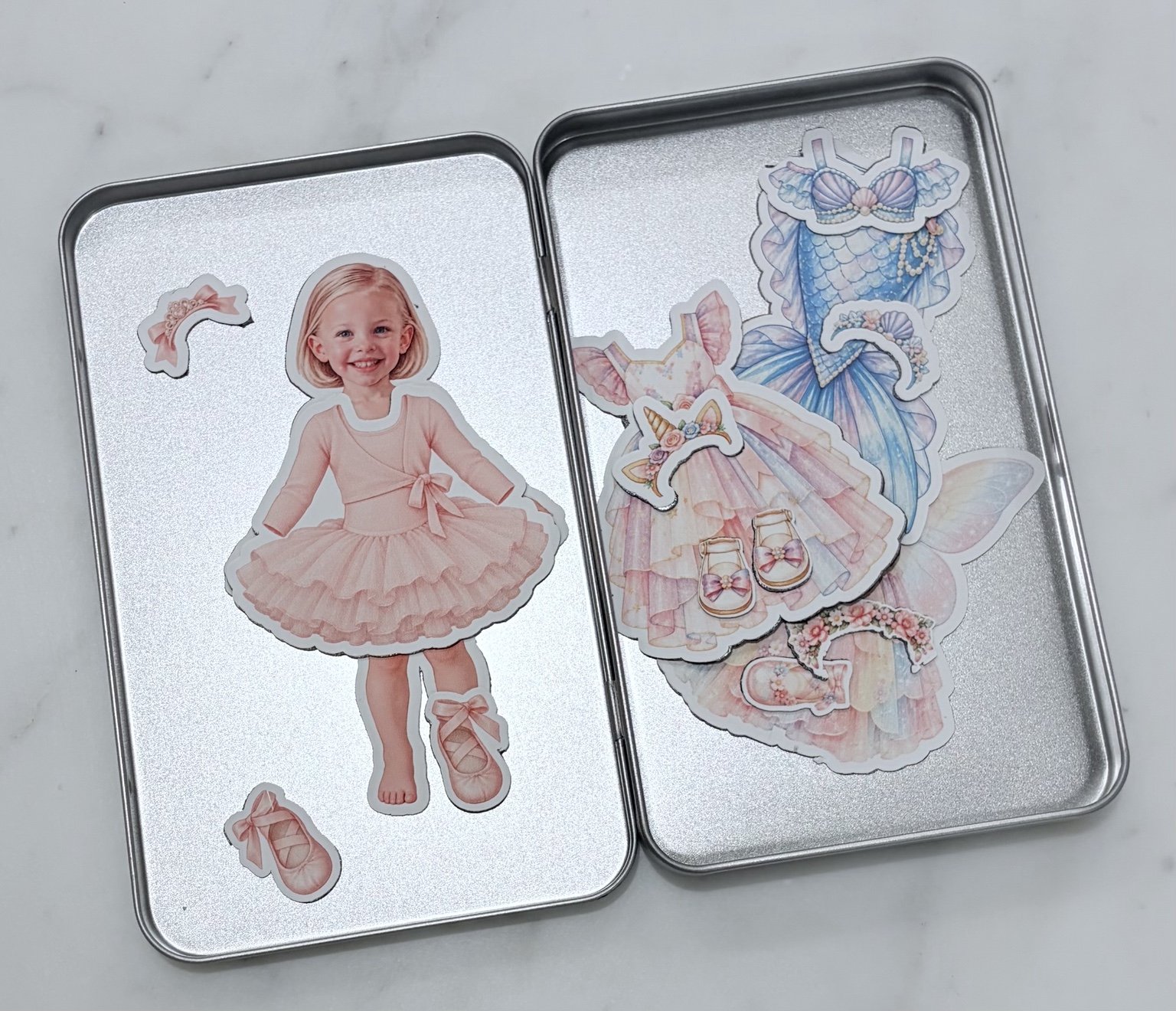 Girl doll dressed as ballerina in an open magnetic keepsake tin